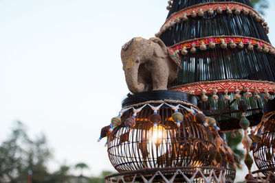 Low angle view of illuminated decoration against clear sky