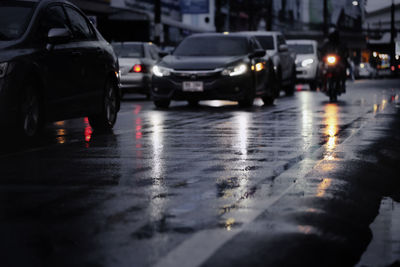 Cars on city street during rainy season