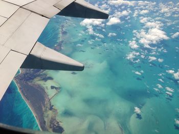 Cropped image of airplane over sea