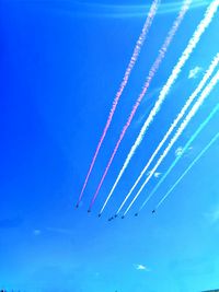Low angle view of airplane flying against blue sky