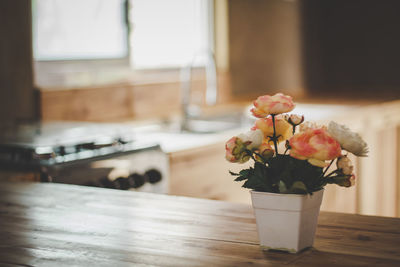 Close-up of flower vase on table at home