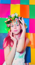 Portrait of young woman with multi colored flower