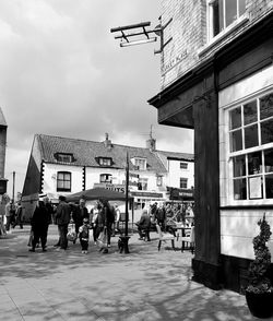 People in town square against sky