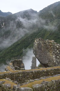 Scenic view of waterfall in mountains