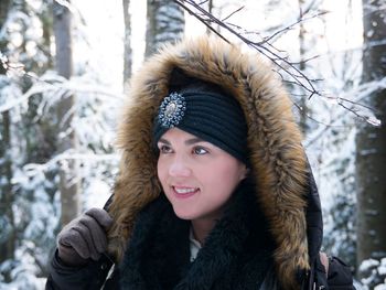 Close-up of smiling young woman wearing fur coat