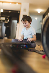 Boy playing with toy racetrack