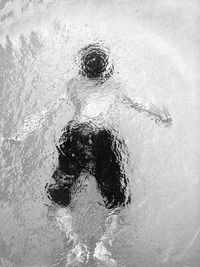 High angle view of people standing on snow covered field