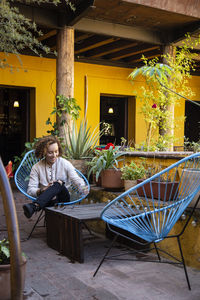 Woman sitting on chair at table