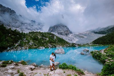 Panoramic view of lake by mountains against sky