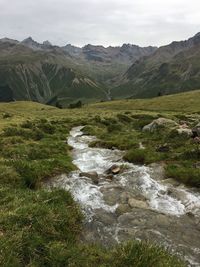 Scenic view of waterfall against sky