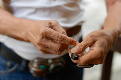 Cropped hand of man holding ring