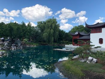 Scenic view of lake by buildings against sky