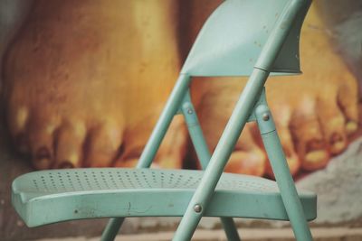 Close-up of chair against wall