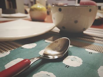 Close-up of plate and spoon on table