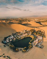 High angle view of city lit up at sunset