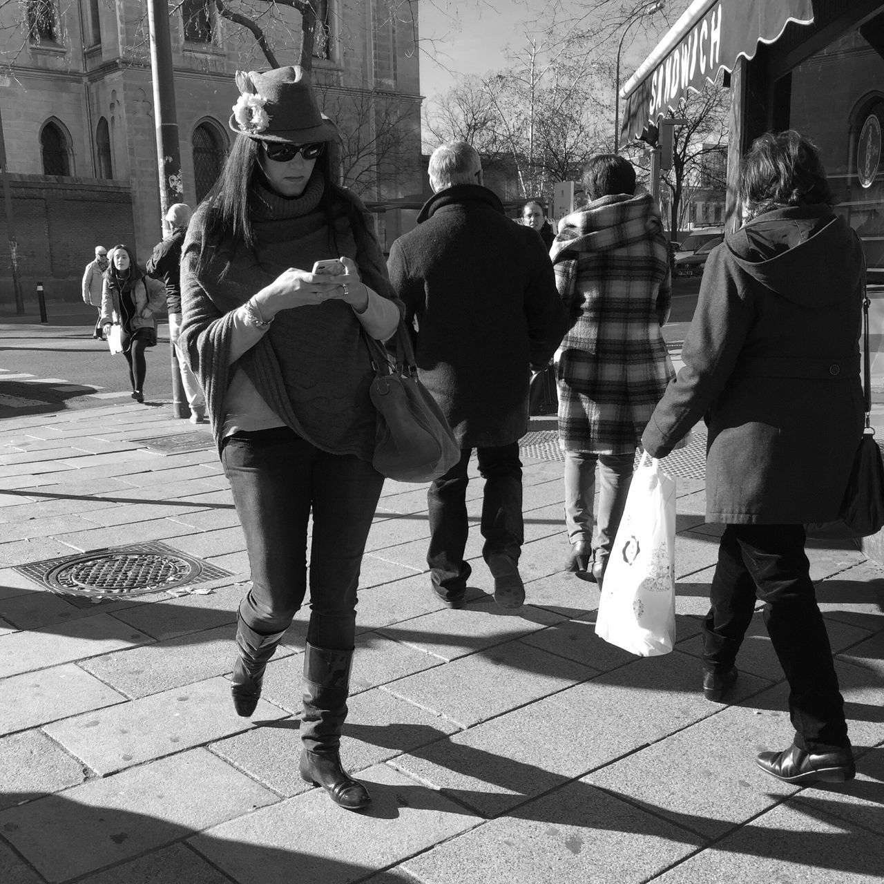 lifestyles, full length, men, walking, building exterior, street, leisure activity, casual clothing, city, city life, togetherness, person, architecture, built structure, sunlight, shadow, rear view, bonding