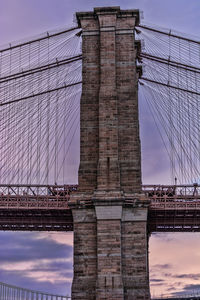 Low angle view of bridge against cloudy sky