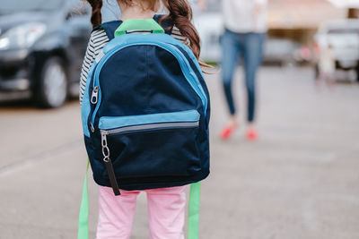 Rear view of woman walking on street