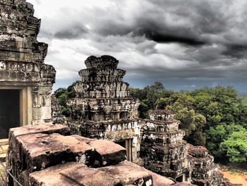 Low angle view of old ruin against cloudy sky