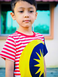 Portrait of boy standing outdoors