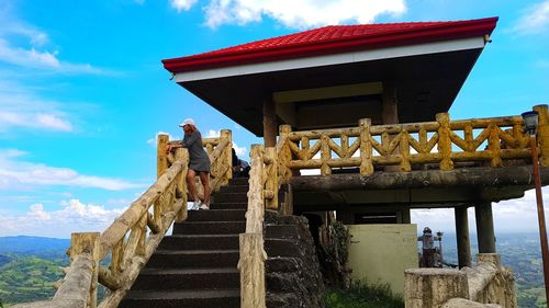 Low angle view of statues on steps against sky