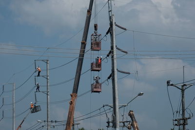 Low angle view of electricity pylon against sky