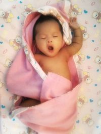 Cute baby girl sleeping on bed