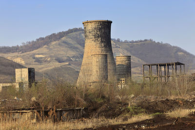 Built structure on landscape against sky