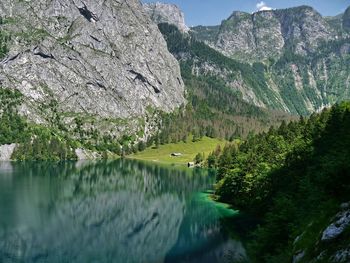 Scenic view of lake by trees against sky