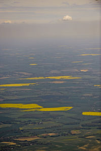 Aerial view of yellow land against sky