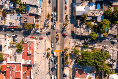 Aerial view of the street intersection with cars driving down the road.