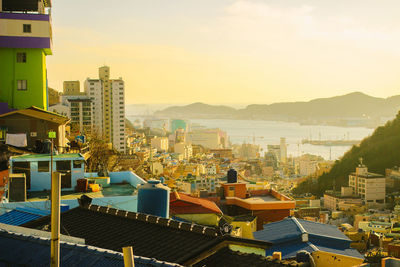 High angle view of buildings in city against sky during sunset