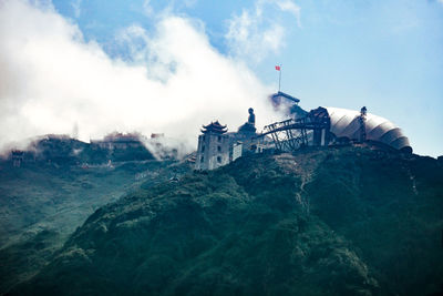 Panoramic view of building and mountains against sky