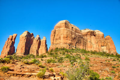 Rock formations on mountain against clear blue sky