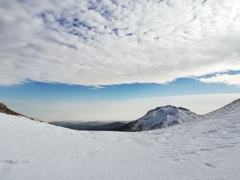 Scenic view of snow mountains against sky