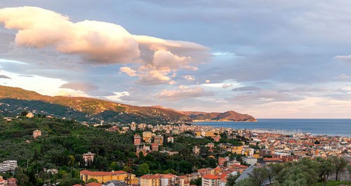 High angle view of townscape by sea against sky