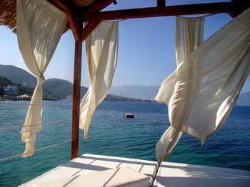 Swimming pool by sea against sky