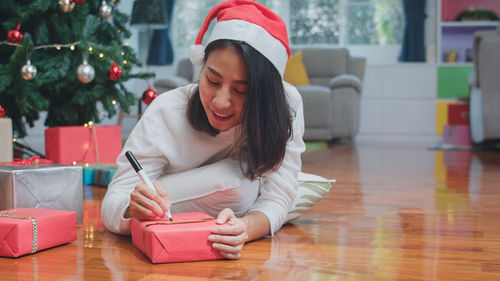 Young woman sitting on table at home