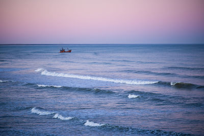 Scenic view of sea against clear sky during sunset