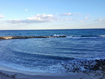 Scenic view of sea against blue sky