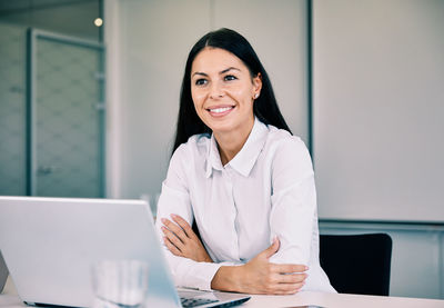 Smiling businesswoman sitting in office