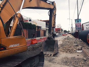 Construction site in city against sky