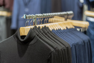 Close-up of clothes hanging on rack at store