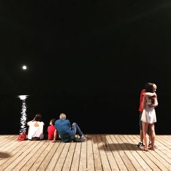 Rear view of people sitting outdoors