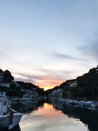 Boats in lake at sunset