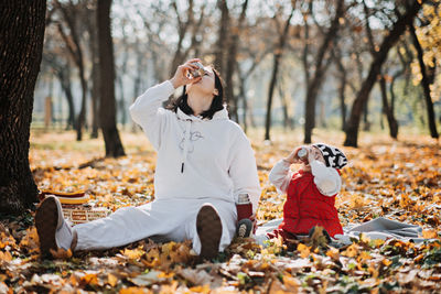 Family fall activities. happy family single mom and toddler baby girl playing outdoors in fall park