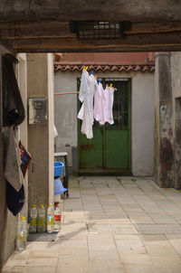 Clothes drying on footpath against building