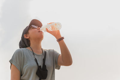 Tourist woman hydrating drinking water from bottle