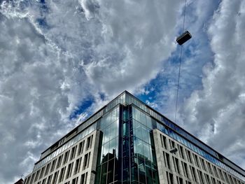 Low angle view of building against cloudy sky