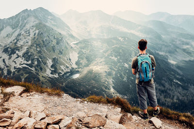 Rear view of man standing on mountain